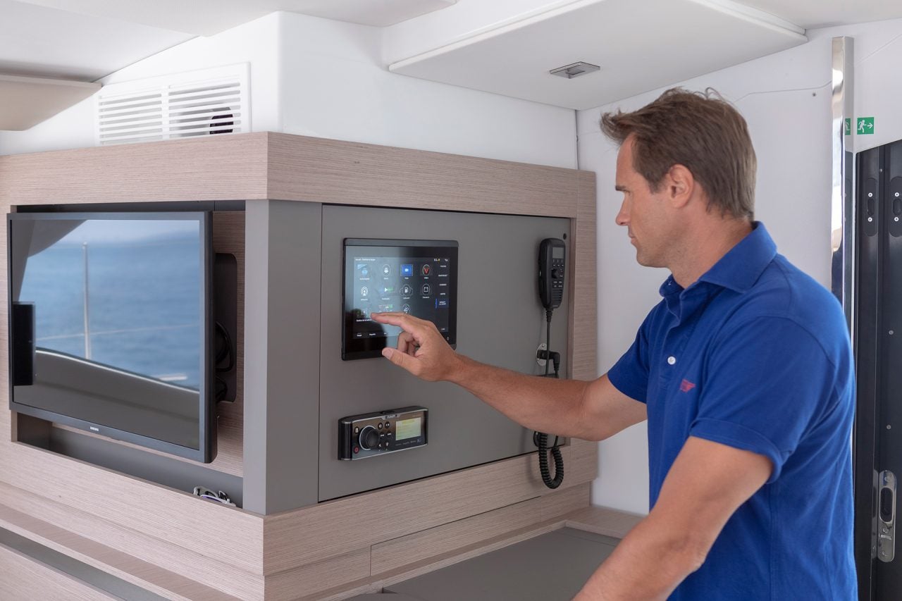 Man looking at electronics station on Elba 45 catamaran