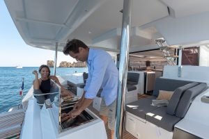 Couple grilling on Elba 45 catamaran sailboat