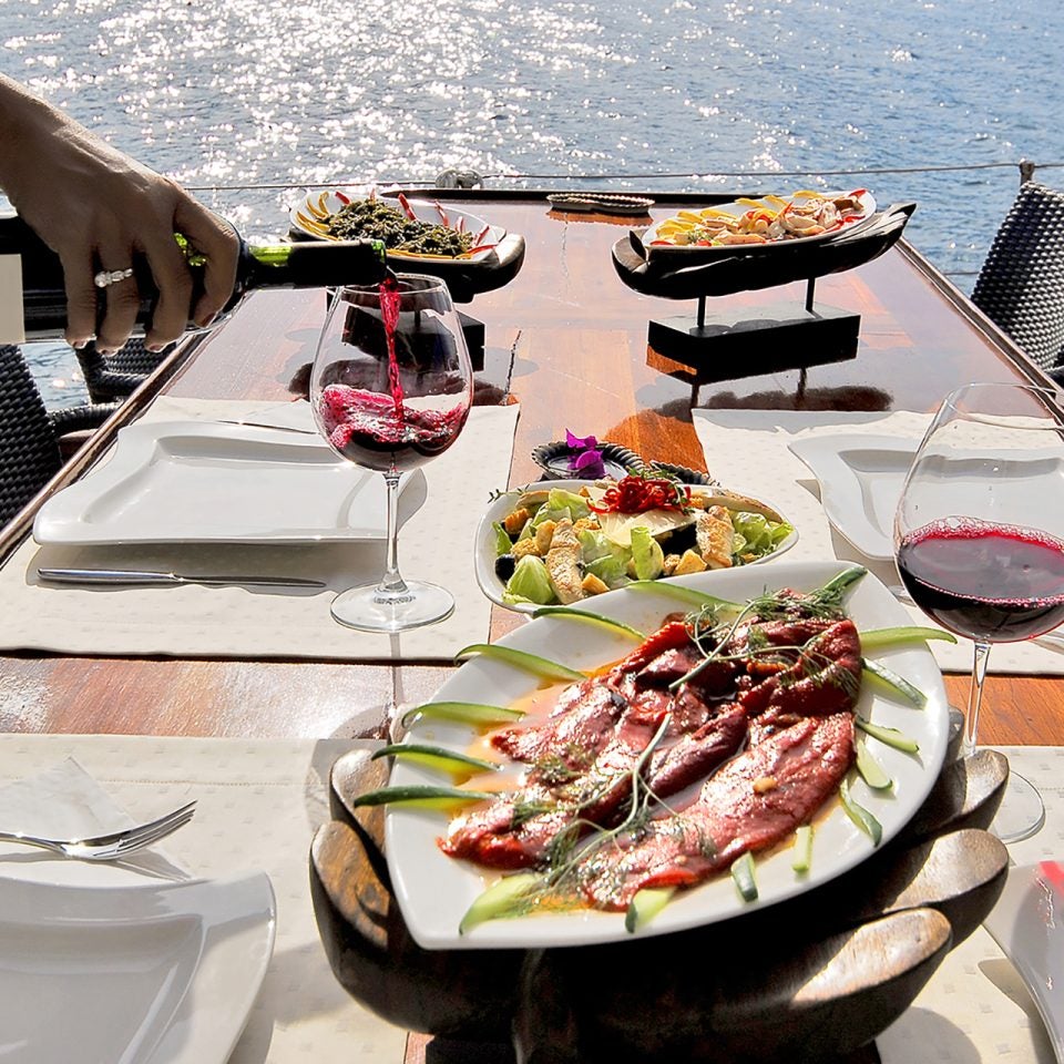 Dream Crewed yacht dining table with crew service and food