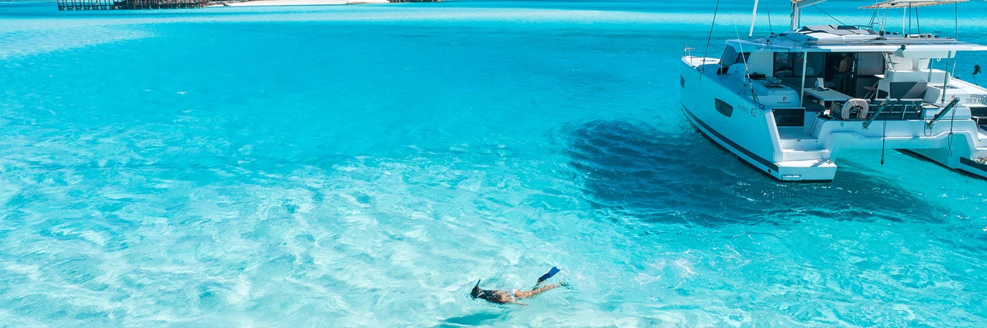 Woman snorkeling near boat charter yacht in ownership program