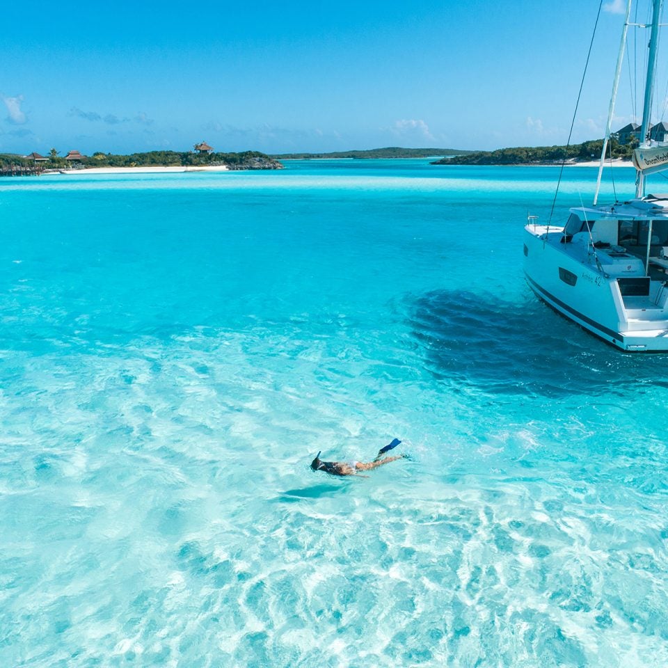 Woman snorkeling near boat charter yacht in ownership program