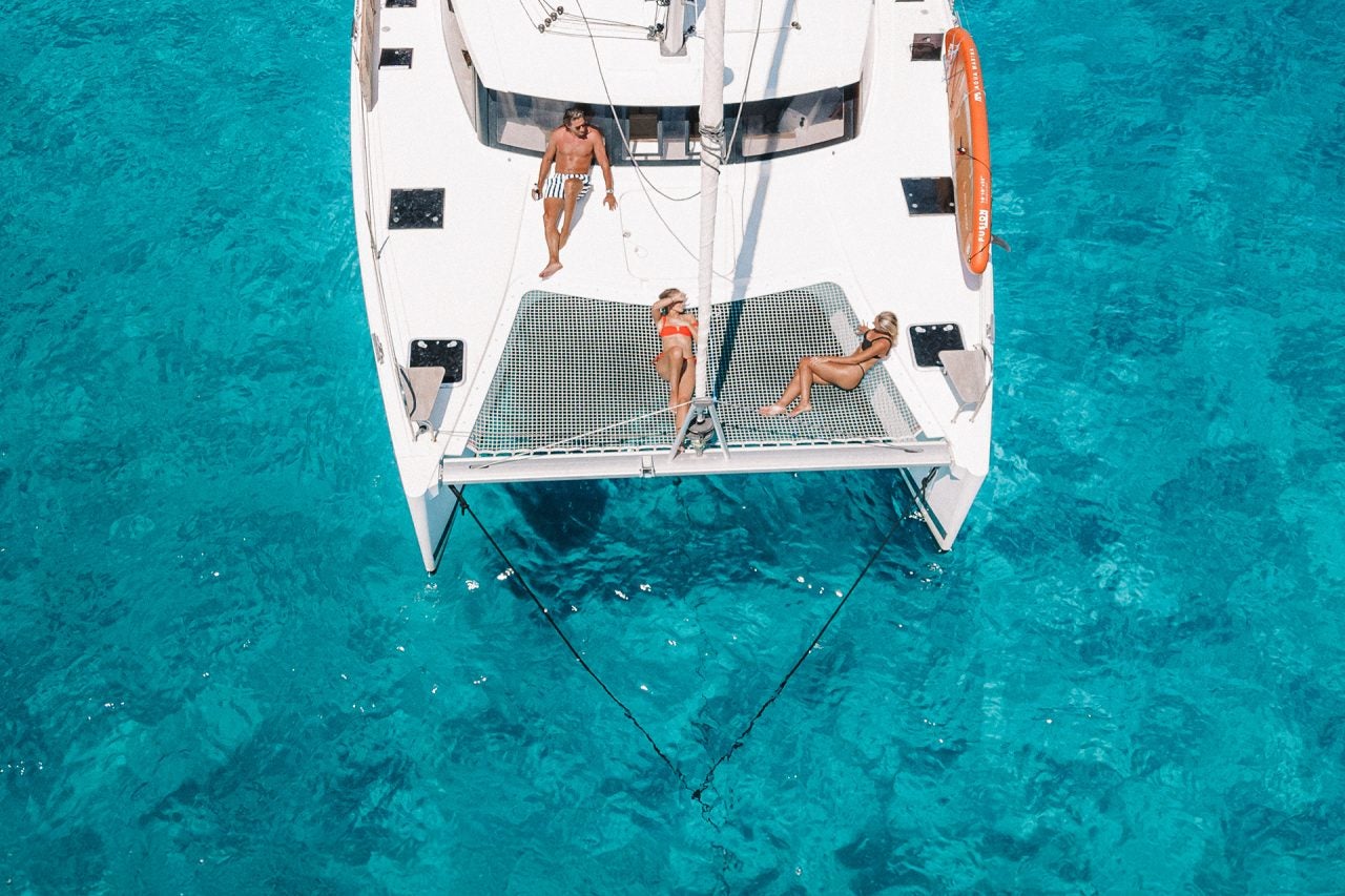 People enjoying deck of yacht in a brokerage ownership program