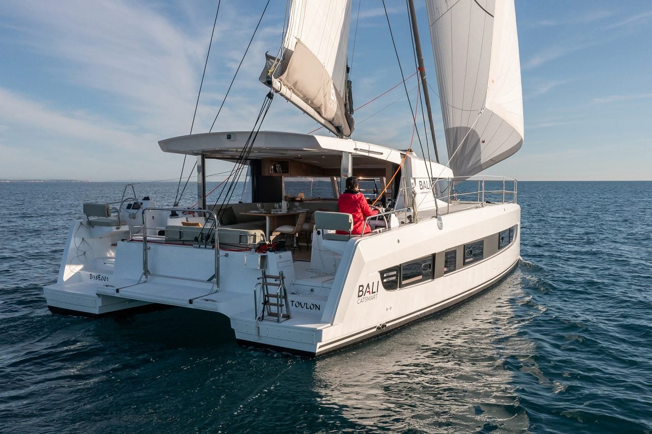 Woman sailing Bali Catsmart catamaran on ocean