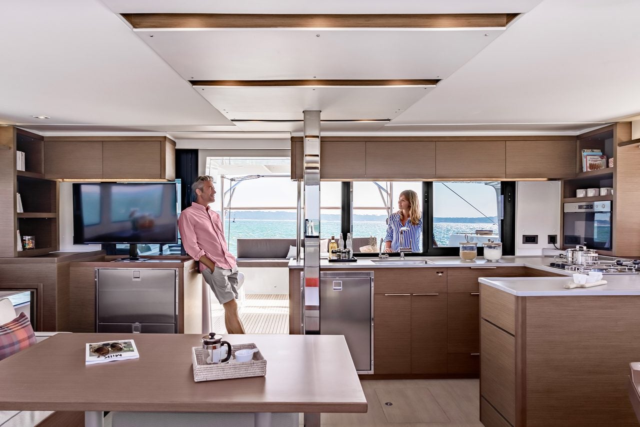 Lagoon 46 yacht saloon interior wide view with family