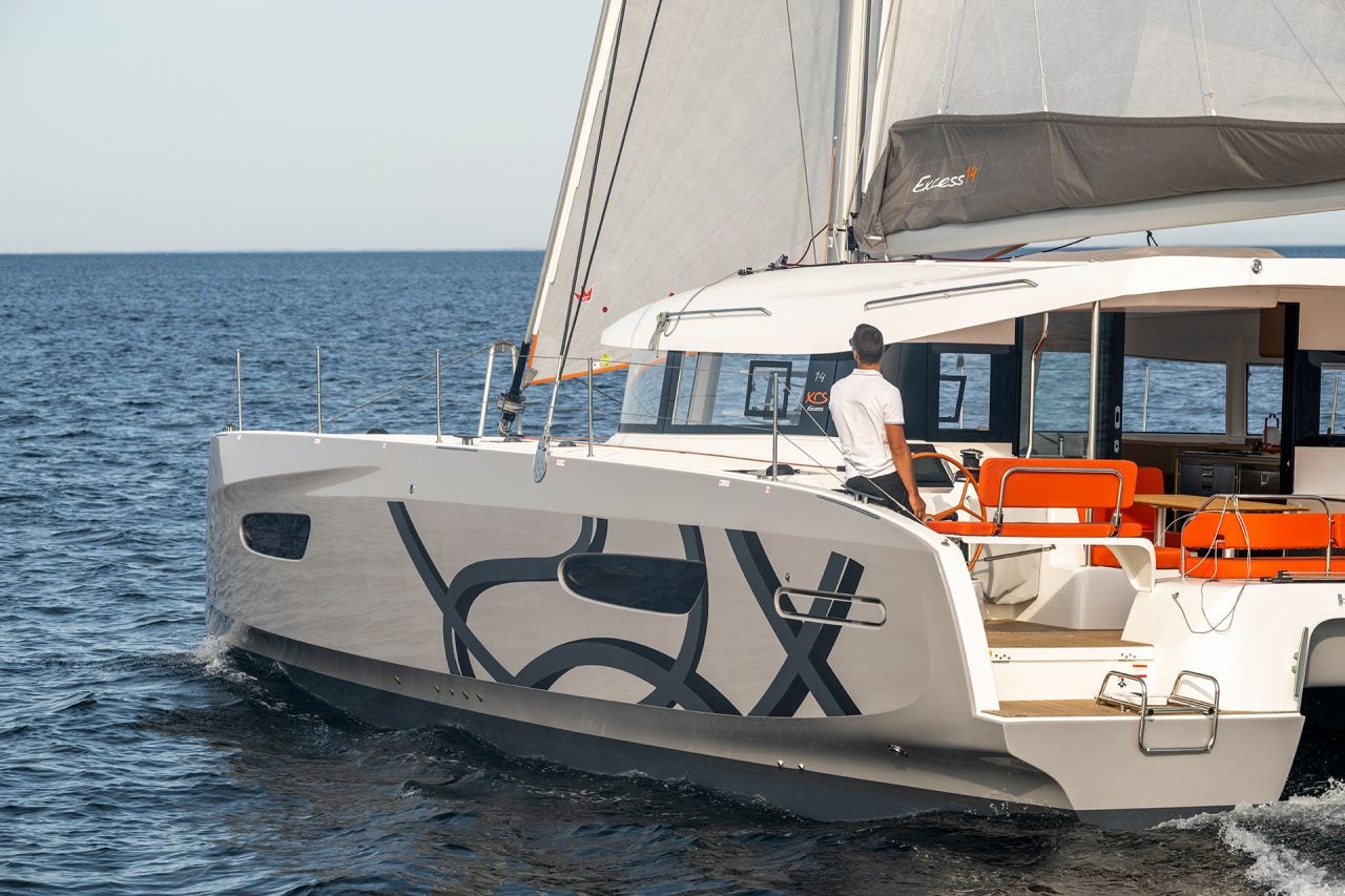 Man at helm of Excess 14 yacht sailing