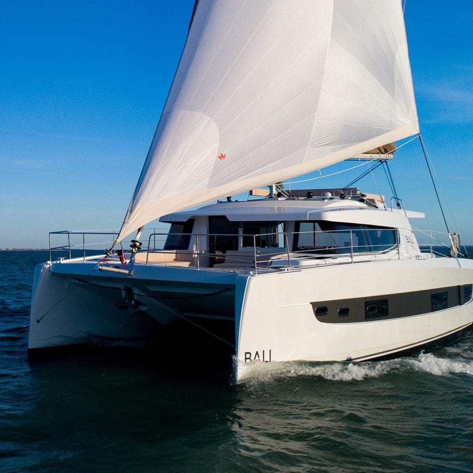 Bali 4.4 catamaran sailing with blue sky backdrop