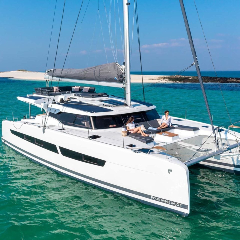 Fountaine Pajot Astrea 42 sailing catamaran at anchor near beach