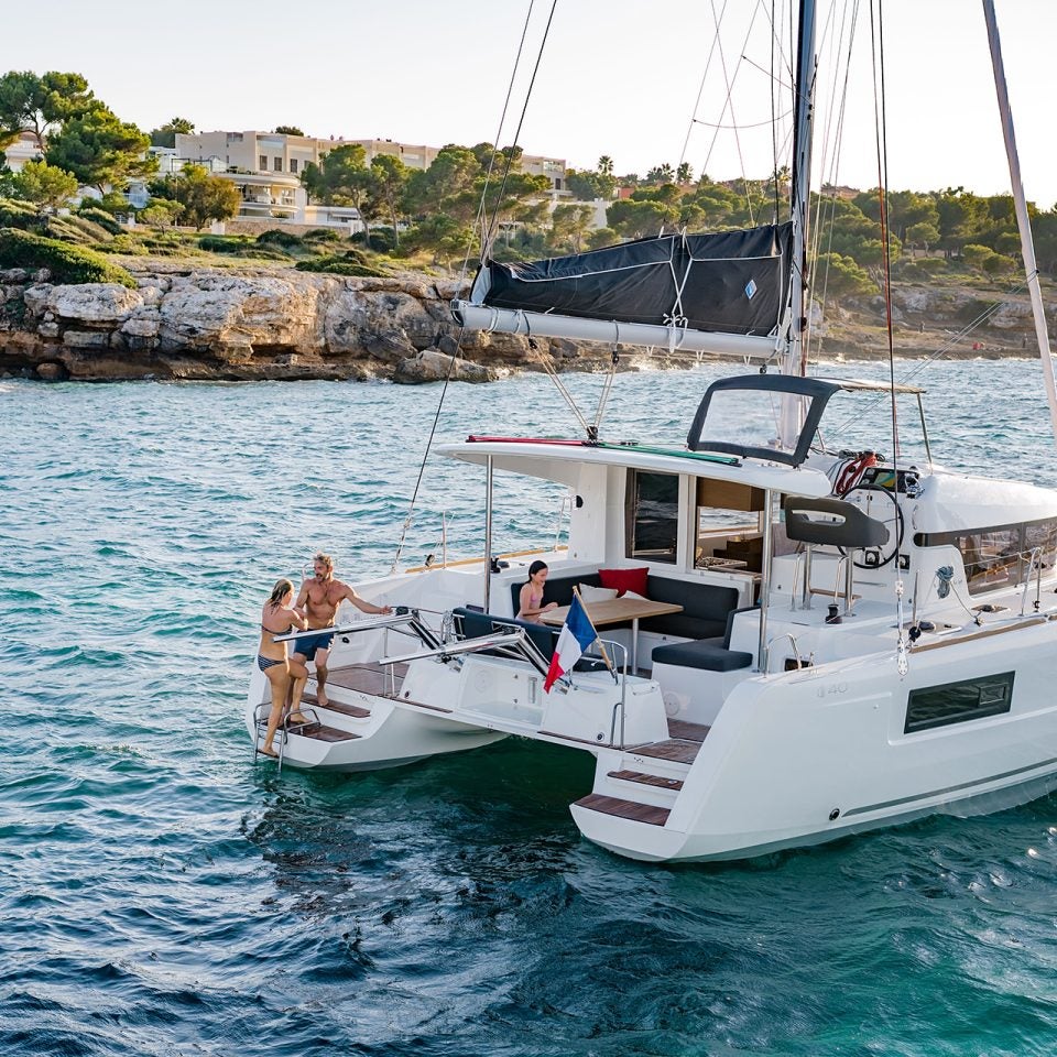 People aboard an anchored Lagoon 40 catamaran