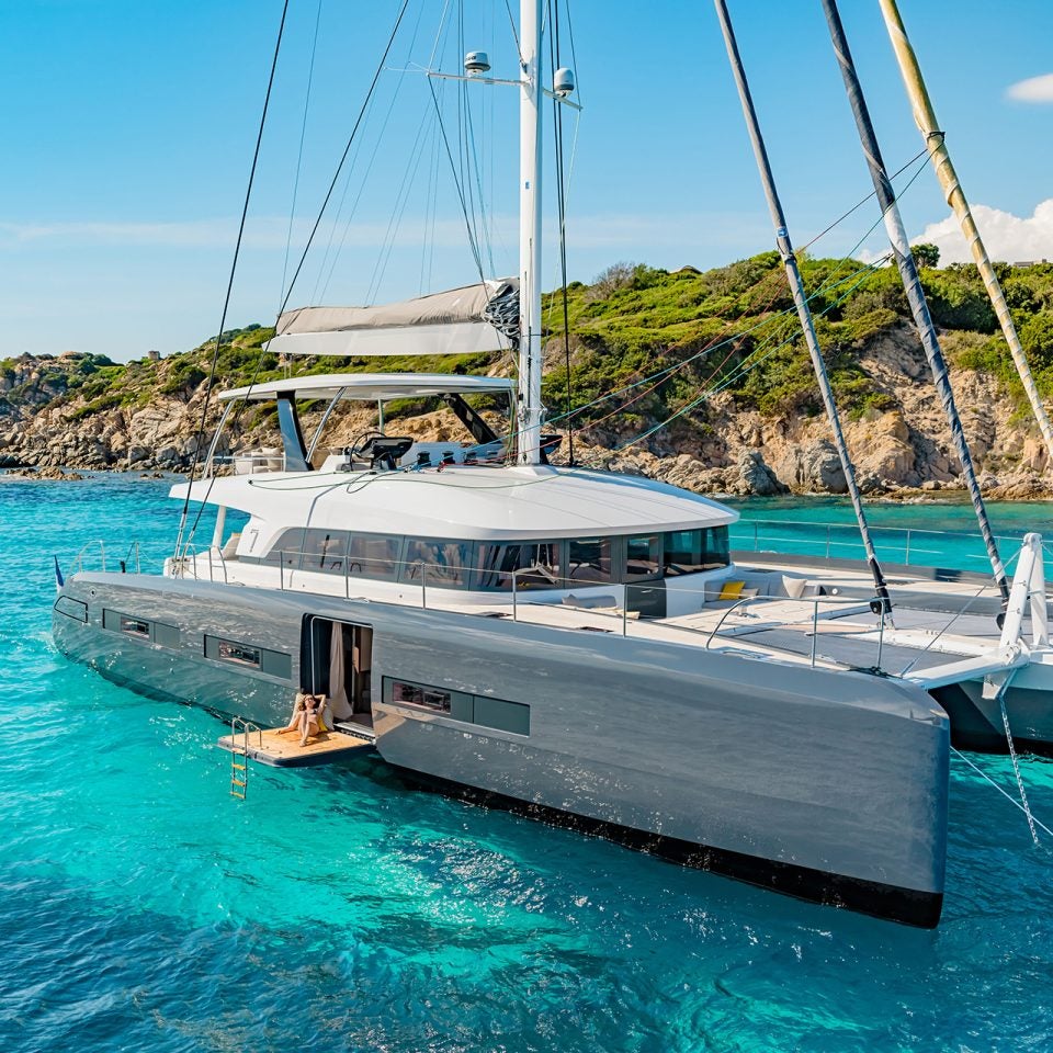 Lagoon seventy 7 luxury sailing catamaran at anchor near shore