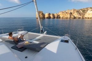 Man on front deck seating of the Fountaine Pajot Elba 45 sailing catamaran