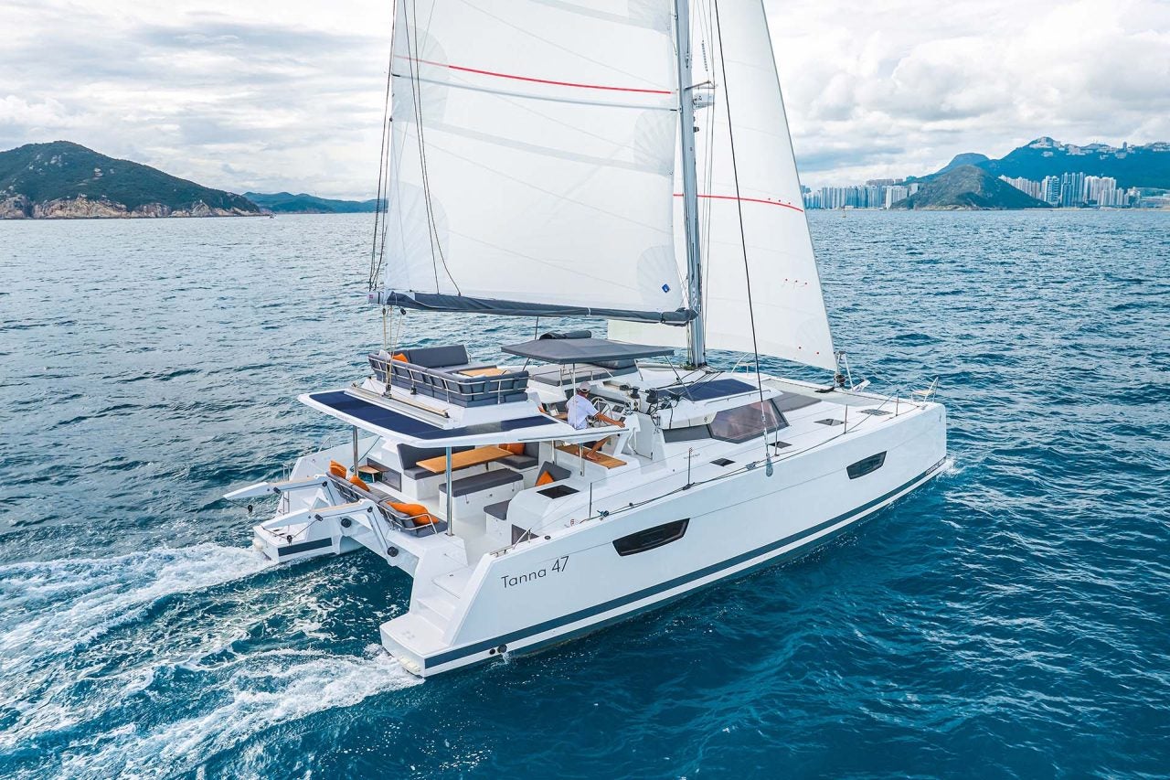 Fountaine Pajot Tanna 47 catamaran sailing with islands in distance