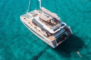 Aerial view of a Alegria 67 sailing catamaran anchored in blue water