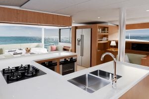 Large u-shaped kitchen with light wood details on the Bali 5.8 luxury yacht