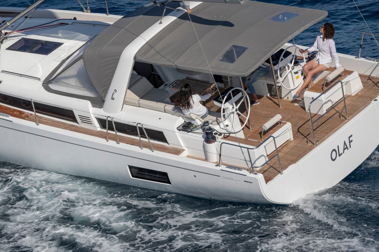 Cockpit view of Oceanis Yacht 54 sailing yacht with woman at helm