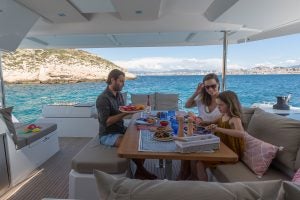 Family dining in the cockpit on the Astrea 42 sailing catamaran