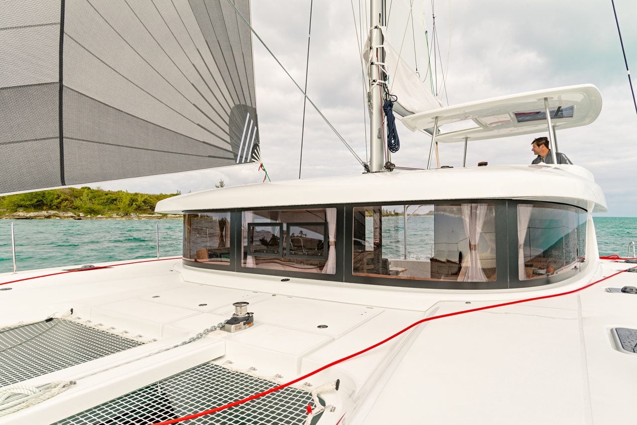 Man at the helm of the Lagoon 42 yacht