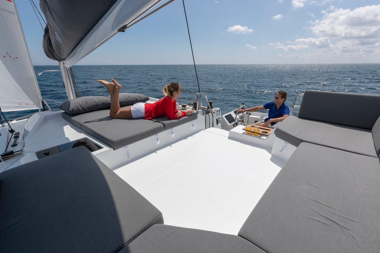 Couple on flybridge of the Smart electric Pajot Elba 45 catamaran