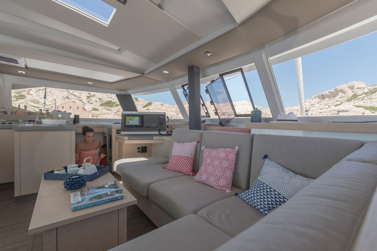 Fountaine Pajot  67 catamaran salon lounge area with wrap windows