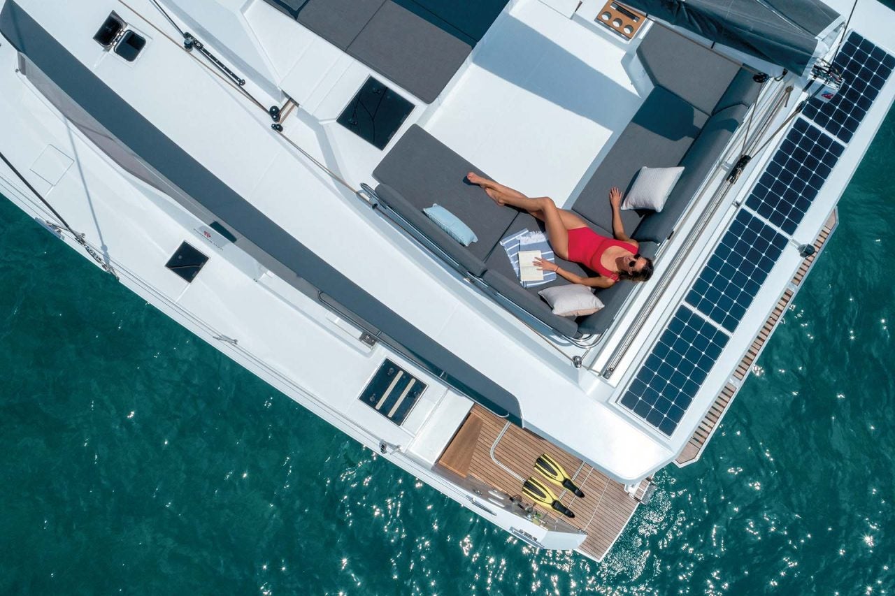 Top view of woman lounging on flybridge of the Elba 45 sailing catamaran