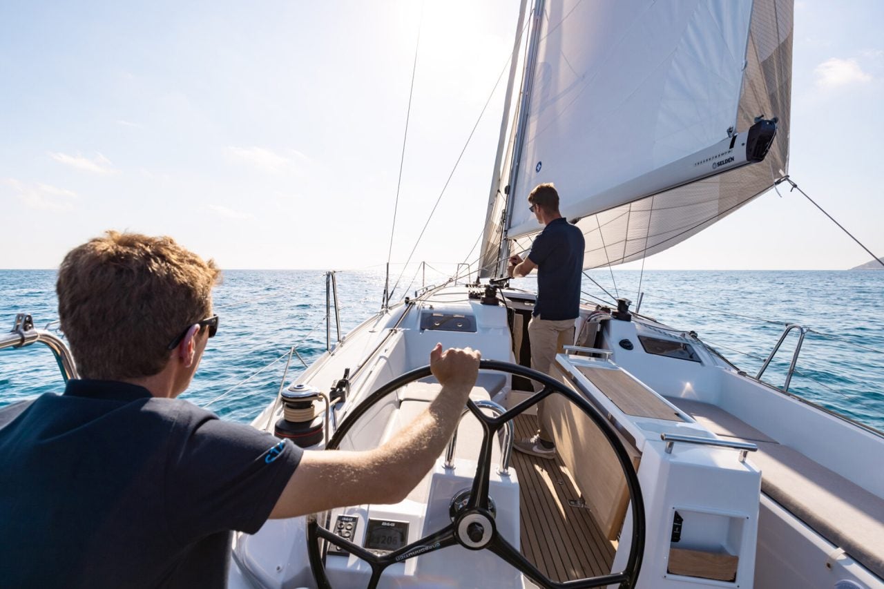 Men in cockpit sailing the Beneteau Oceanis 34.1 sailboat