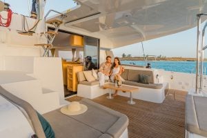 Couple seated in cockpit of the Lagoon 42 sailing catamaran