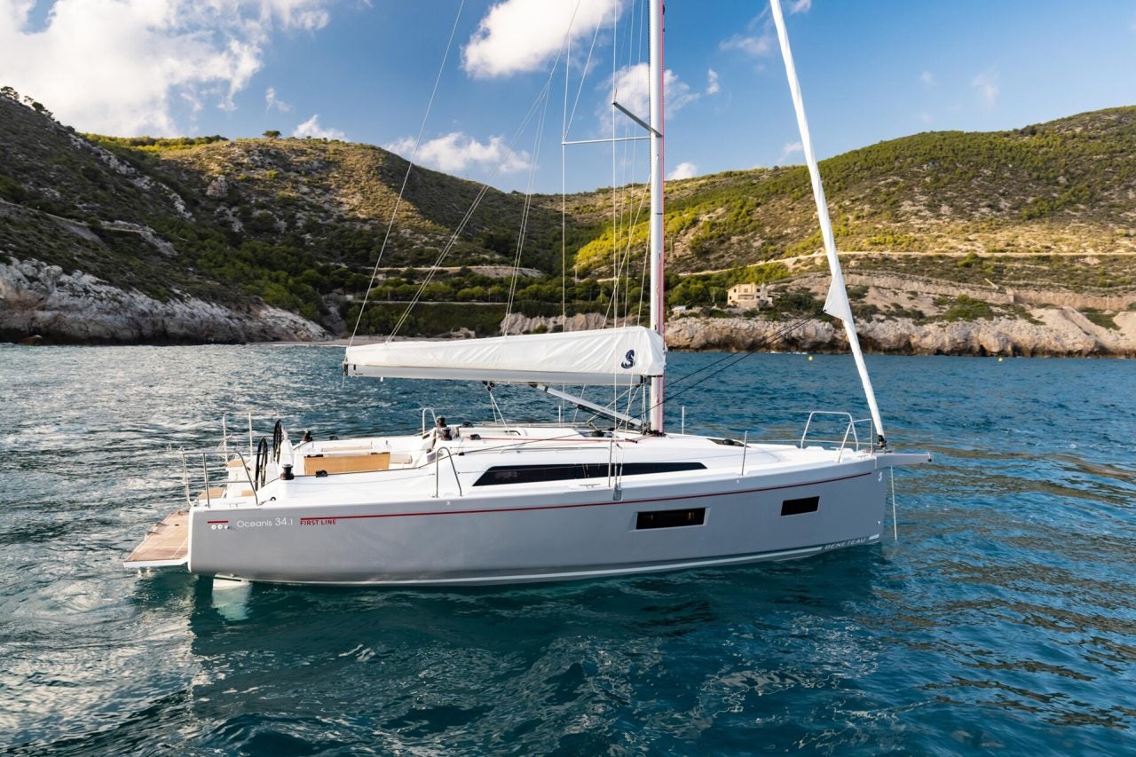 Beneteau 34.1 sailboat at anchor near scenic shore