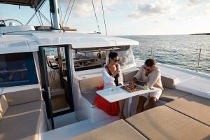 People enjoying the foredeck table of the Bali 4.2