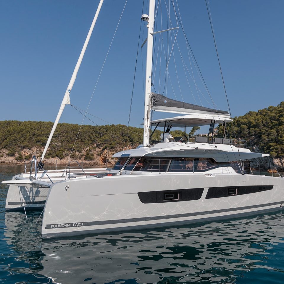 Fountaine Pajot Samana 59 yacht at anchor near coastline